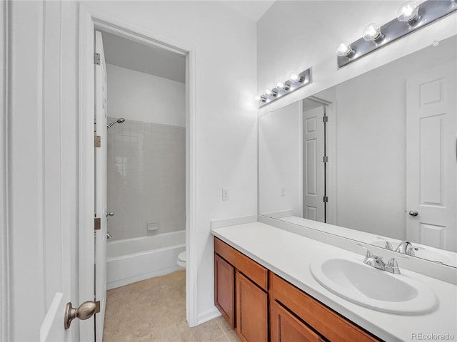 full bathroom featuring tile patterned floors, tiled shower / bath combo, vanity, and toilet