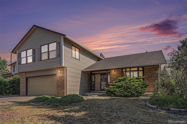 17583 E Belleview Pl, Centennial, CO 80015 - view of front of home with brick siding, a garage, driveway, and a yard