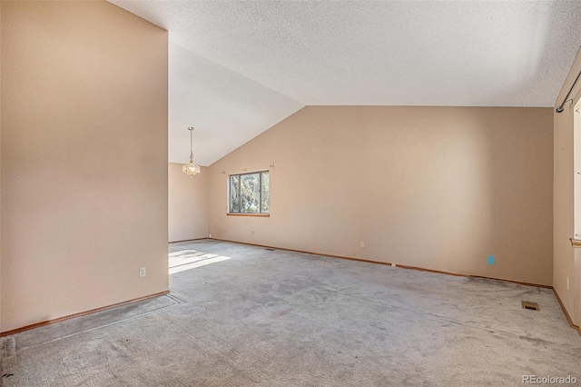17583 E Belleview Pl, Centennial, CO 80015 - spare room featuring carpet floors, lofted ceiling, and a textured ceiling