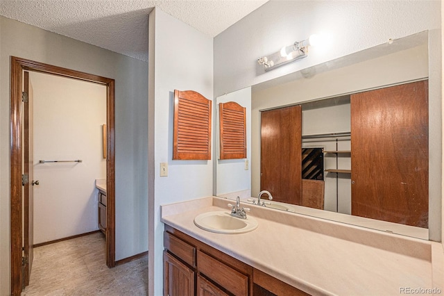 17583 E Belleview Pl, Centennial, CO 80015 - bathroom featuring vanity and a textured ceiling