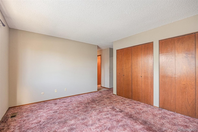 17583 E Belleview Pl, Centennial, CO 80015 - unfurnished bedroom with two closets, carpet floors, and a textured ceiling