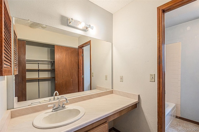 17583 E Belleview Pl, Centennial, CO 80015 - full bath featuring vanity, a textured ceiling, and shower / bath combination