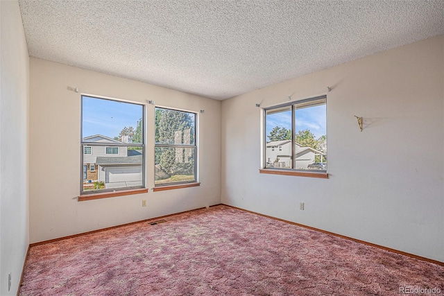 17583 E Belleview Pl, Centennial, CO 80015 - carpeted empty room featuring healthy amount of natural light and a textured ceiling