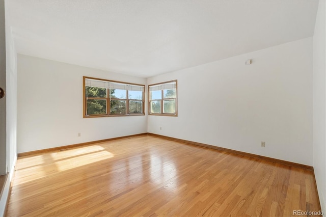 unfurnished room with light hardwood / wood-style floors