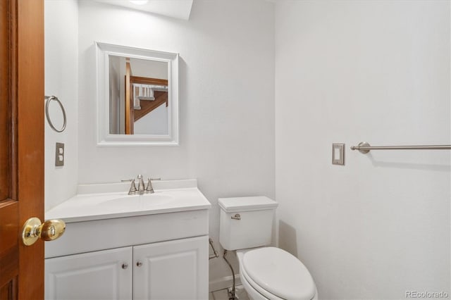 bathroom featuring toilet and vanity