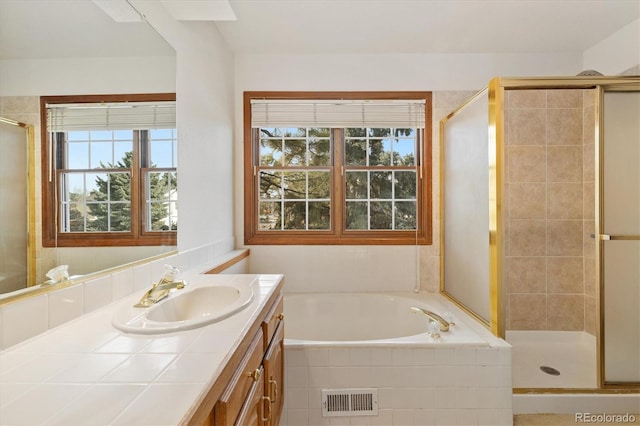 bathroom featuring separate shower and tub and vanity