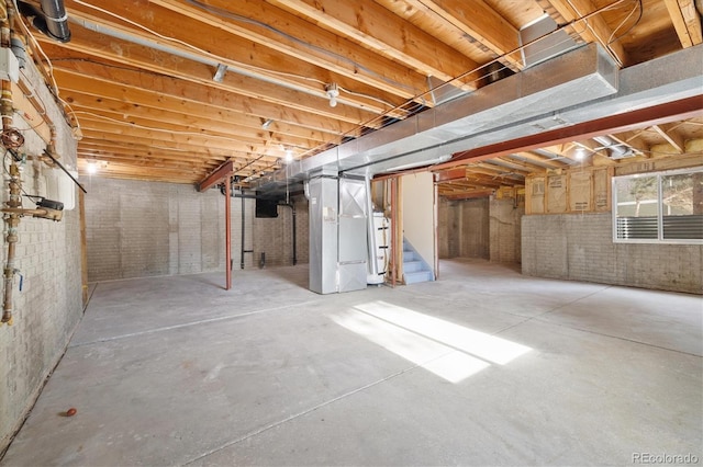 basement featuring water heater and heating unit