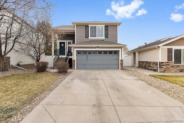 view of front of house with driveway, a garage, and roof with shingles