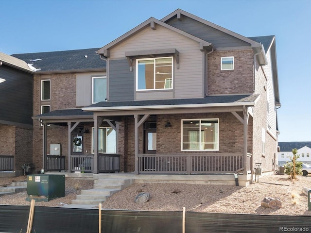20982 E 66th Ave, Aurora, CO 80019 - view of front of house featuring brick siding and covered porch