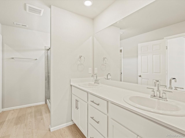 20982 E 66th Ave, Aurora, CO 80019 - bathroom featuring wood finished floors, a sink, and visible vents