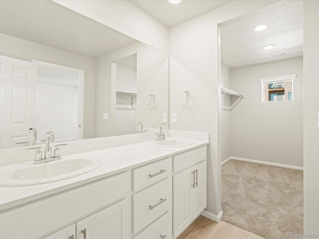 20982 E 66th Ave, Aurora, CO 80019 - bathroom featuring baseboards, visible vents, a sink, and double vanity