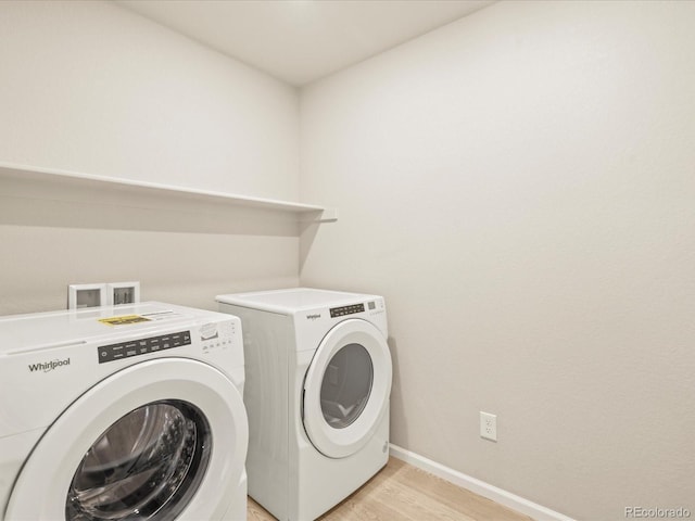20982 E 66th Ave, Aurora, CO 80019 - clothes washing area with washer and dryer, baseboards, laundry area, and light wood-style flooring