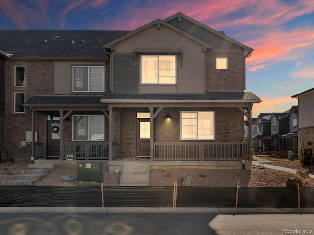 20982 E 66th Ave, Aurora, CO 80019 - view of front of home with a porch and brick siding