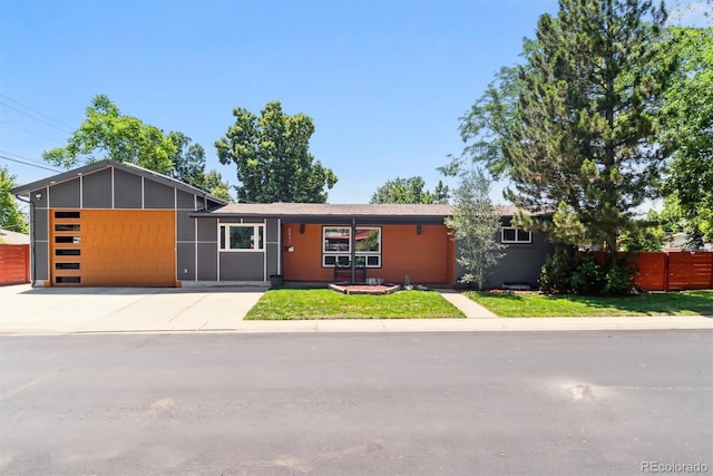 5480 W Iowa Ave, Lakewood, CO 80232 - view of front of house with a garage and concrete driveway