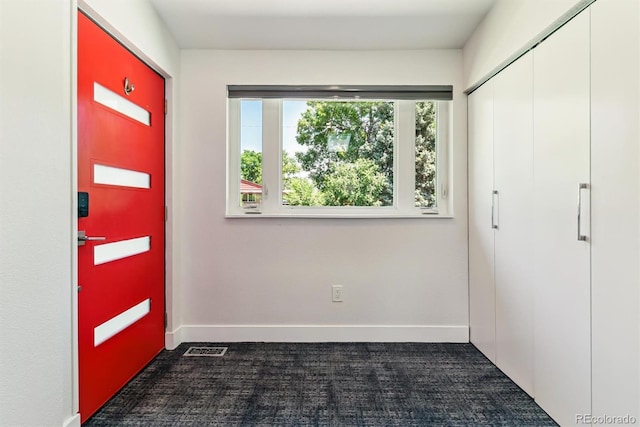 5480 W Iowa Ave, Lakewood, CO 80232 - foyer entrance with dark carpet and baseboards