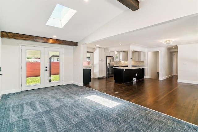 5480 W Iowa Ave, Lakewood, CO 80232 - unfurnished living room featuring a skylight, french doors, recessed lighting, and dark wood-type flooring