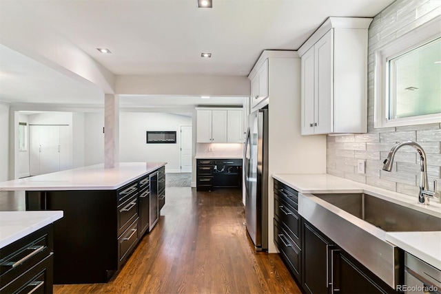 5480 W Iowa Ave, Lakewood, CO 80232 - kitchen featuring white cabinets, light countertops, and dark cabinetry