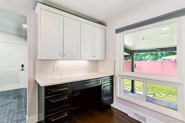 5480 W Iowa Ave, Lakewood, CO 80232 - kitchen with white cabinets, light countertops, and decorative backsplash
