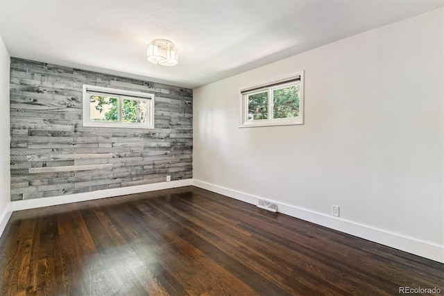 5480 W Iowa Ave, Lakewood, CO 80232 - spare room with wood finished floors, an accent wall, and wooden walls