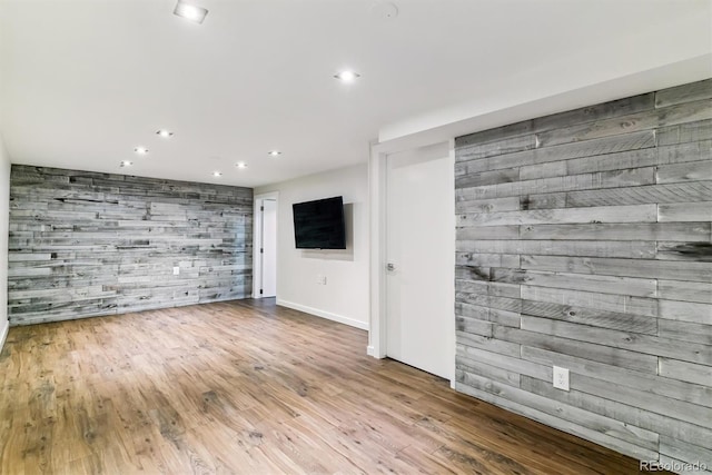 5480 W Iowa Ave, Lakewood, CO 80232 - unfurnished living room with recessed lighting, wood finished floors, an accent wall, and wood walls