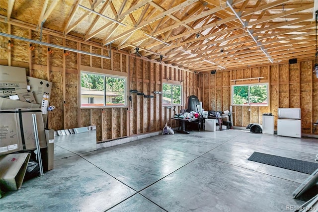 5480 W Iowa Ave, Lakewood, CO 80232 - misc room with concrete floors, healthy amount of natural light, and a garage