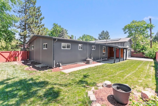 5480 W Iowa Ave, Lakewood, CO 80232 - back of property featuring a patio area, a fenced backyard, solar panels, and stucco siding