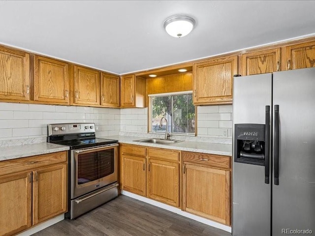 kitchen featuring sink, light stone countertops, dark hardwood / wood-style flooring, appliances with stainless steel finishes, and tasteful backsplash