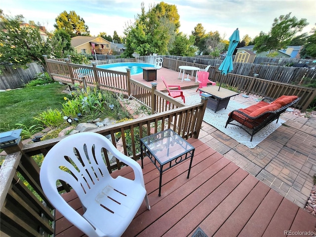 deck featuring a fenced backyard and a fenced in pool