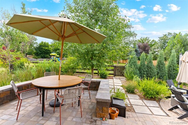 1902 Pioneer Cir, Lafayette, CO 80026 - view of patio featuring outdoor dining space and a playground