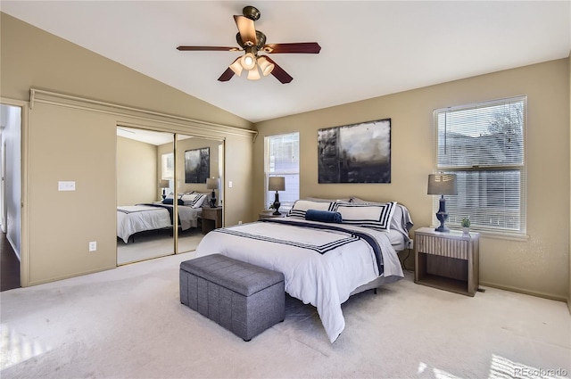 bedroom featuring light carpet, a closet, vaulted ceiling, and ceiling fan