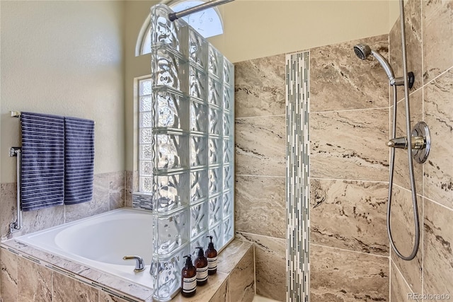 bathroom featuring shower with separate bathtub