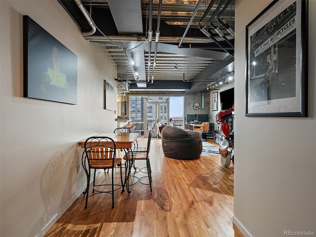 dining space featuring baseboards and wood finished floors