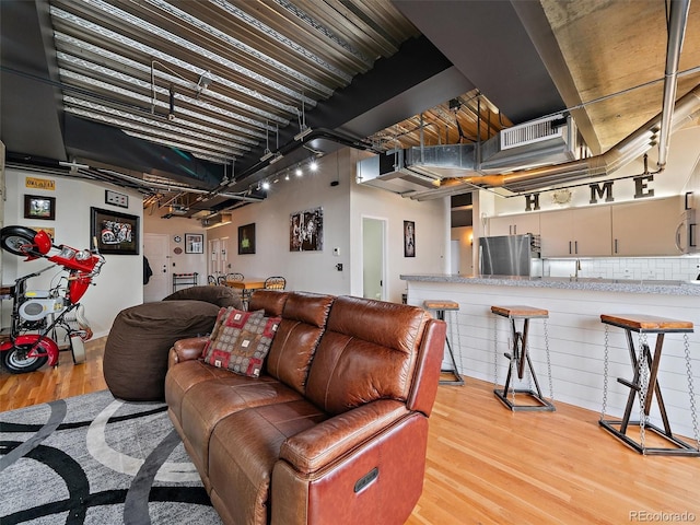 living room featuring light wood-type flooring and visible vents
