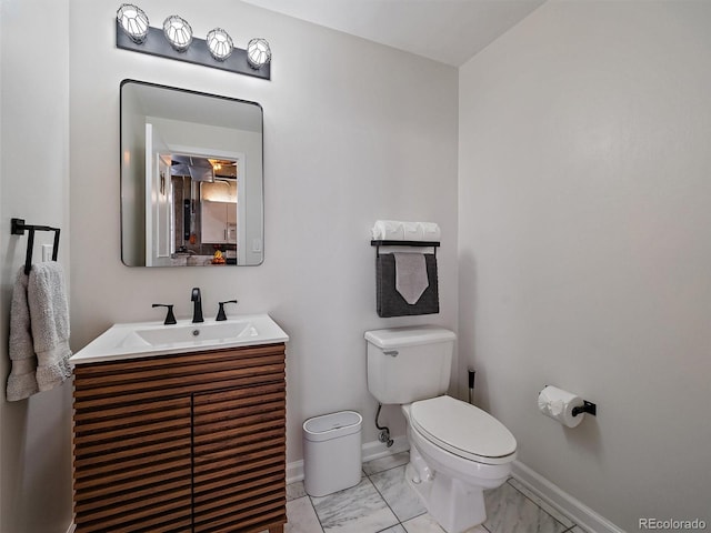 bathroom with vanity, marble finish floor, baseboards, and toilet