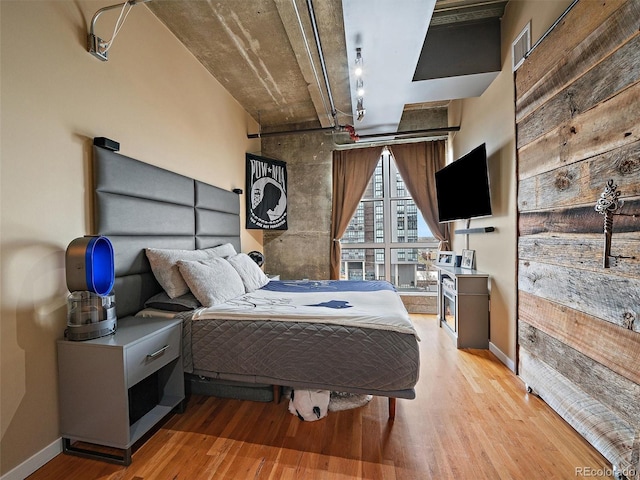 bedroom with baseboards and light wood-type flooring