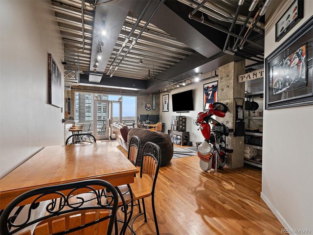 2020 Arapahoe St Unit 1150, Denver, CO 80205 - dining area featuring rail lighting and wood finished floors