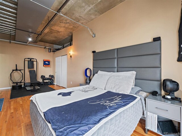 2020 Arapahoe St Unit 1150, Denver, CO 80205 - bedroom featuring wood finished floors, a garage, and a closet