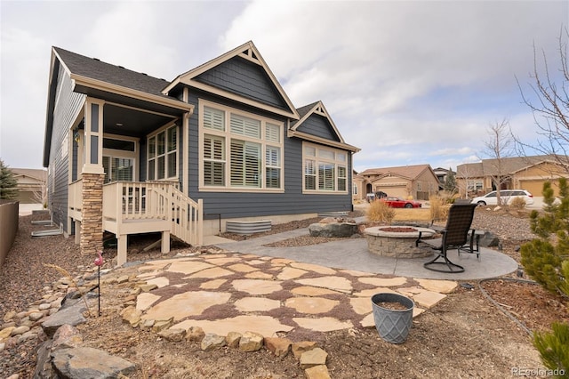 back of house with a patio area and a fire pit