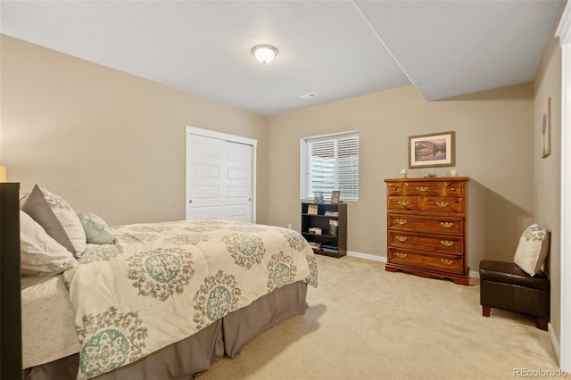 bedroom featuring carpet, a closet, visible vents, and baseboards