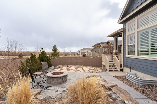 view of patio with an outdoor fire pit and fence