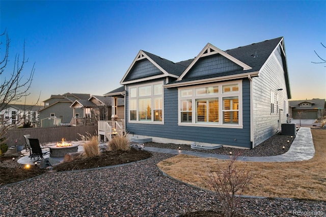 exterior space with a fire pit and central AC unit