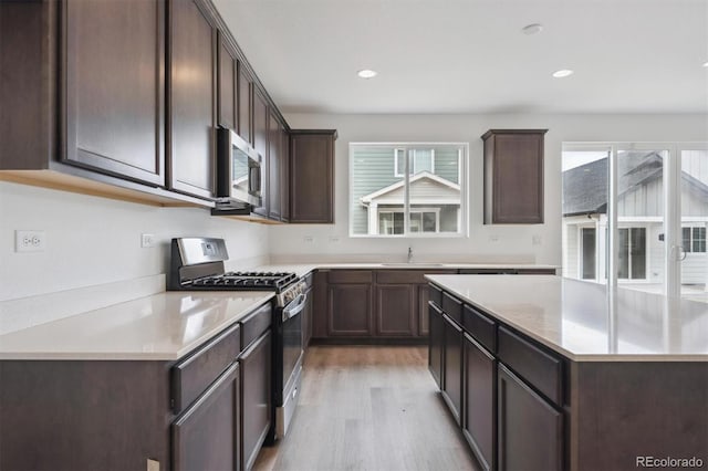 6625 N Nepal St, Aurora, CO 80019 - kitchen with dark brown cabinets, a sink, and stainless steel appliances
