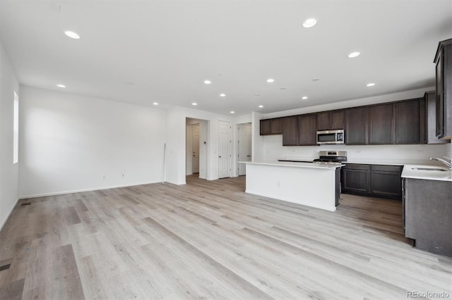 6625 N Nepal St, Aurora, CO 80019 - kitchen featuring a sink, recessed lighting, light wood-style flooring, and appliances with stainless steel finishes