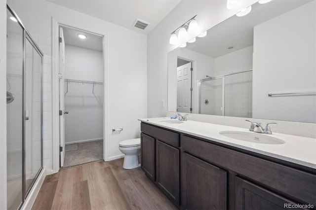 6625 N Nepal St, Aurora, CO 80019 - bathroom with wood finished floors, a sink, a stall shower, and visible vents
