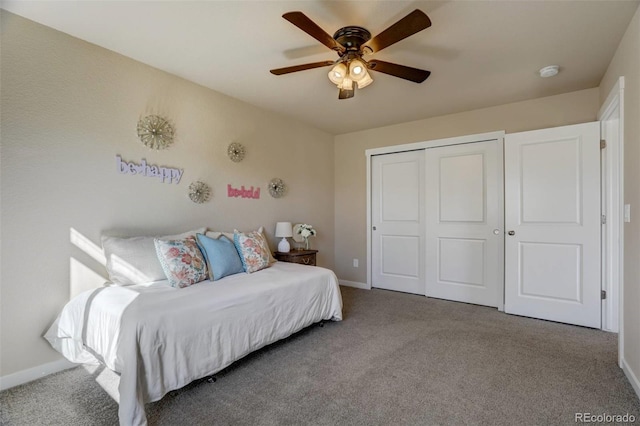 bedroom with a ceiling fan, carpet, a closet, and baseboards