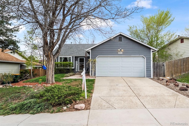 ranch-style house with concrete driveway, fence, a shingled roof, and a garage