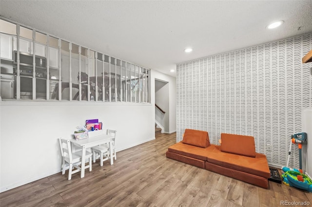 interior space with baseboards, wood finished floors, and recessed lighting