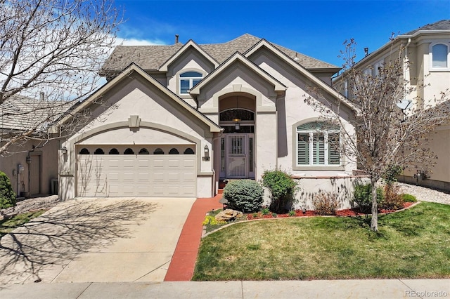 4373 E Phillips Pl, Centennial, CO 80122 - traditional-style home with driveway, roof with shingles, a front yard, an attached garage, and stucco siding