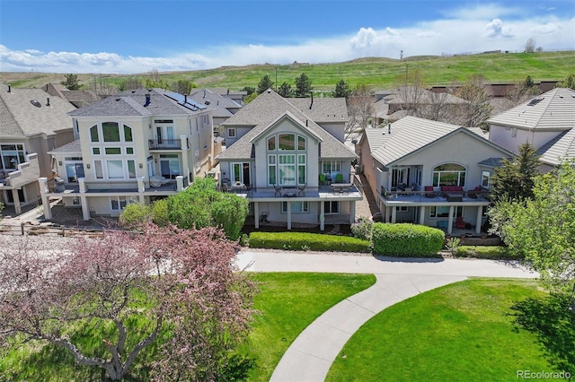 4373 E Phillips Pl, Centennial, CO 80122 - back of house featuring a balcony, stucco siding, a shingled roof, a yard, and a residential view