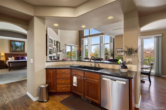 4373 E Phillips Pl, Centennial, CO 80122 - kitchen featuring a sink, dishwasher, arched walkways, dark wood finished floors, and visible vents